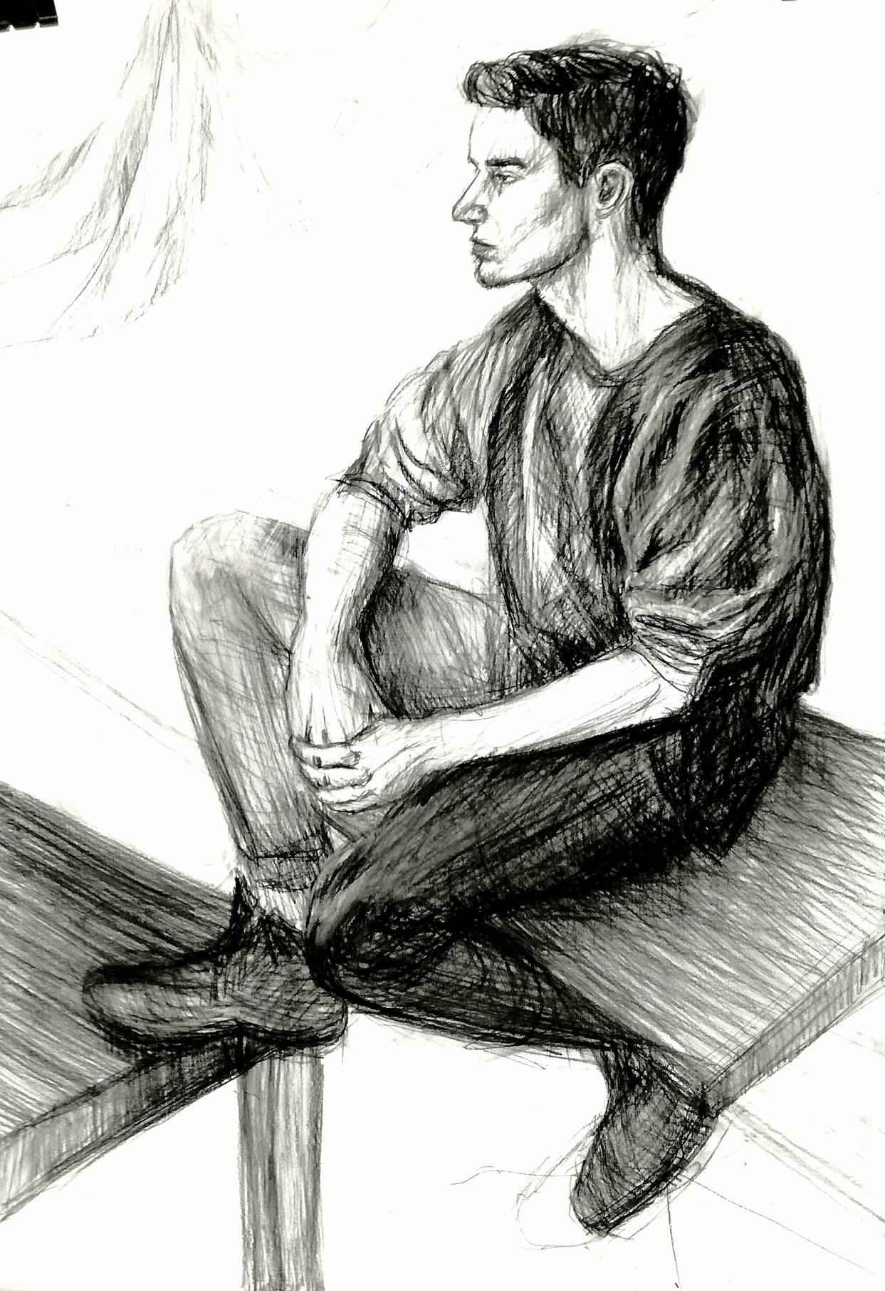 rysunek młody mężczyzna na stole